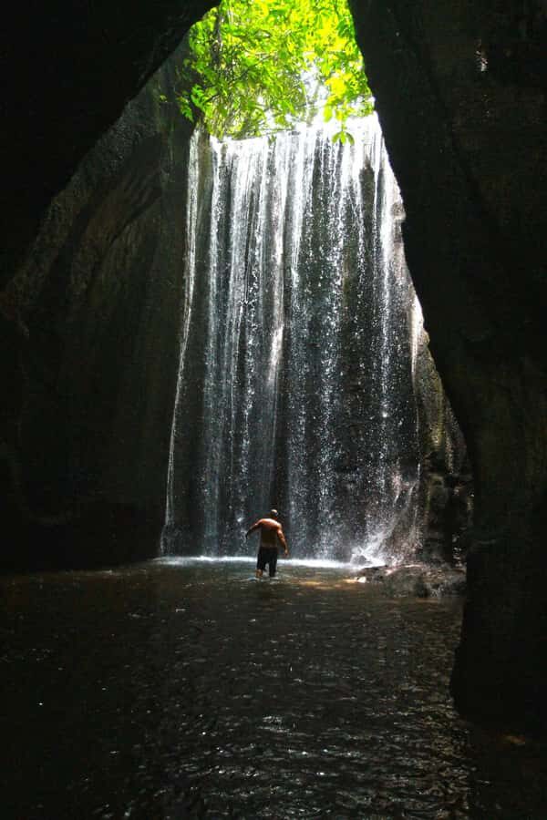 Bali: Gate of Heaven, Waterfall and Ubud All-Inclusive Tour - Tukad Cepung waterfall in a cave: light beams and wet footing