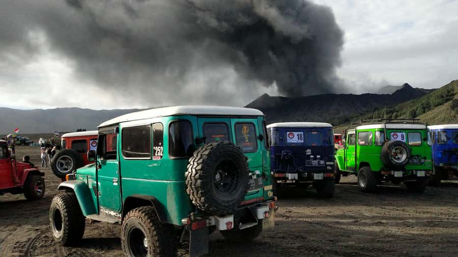 From Probolinggo: Mount Bromo Sunset Tour by Land Cruiser - Eruption Desert Walk and the Widodaren Hill Photo Background