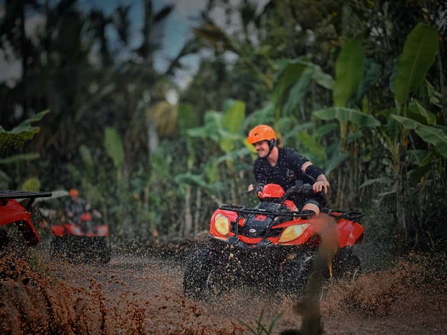 Ubud: Gorilla Face Quad Bike, Jungle Swing, Waterfall & Meal - Goa Raja Waterfall: sun rays, cave-like rock, and camera timing